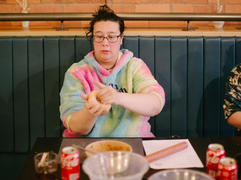 A woman learning how to make dumplings at a cooking class